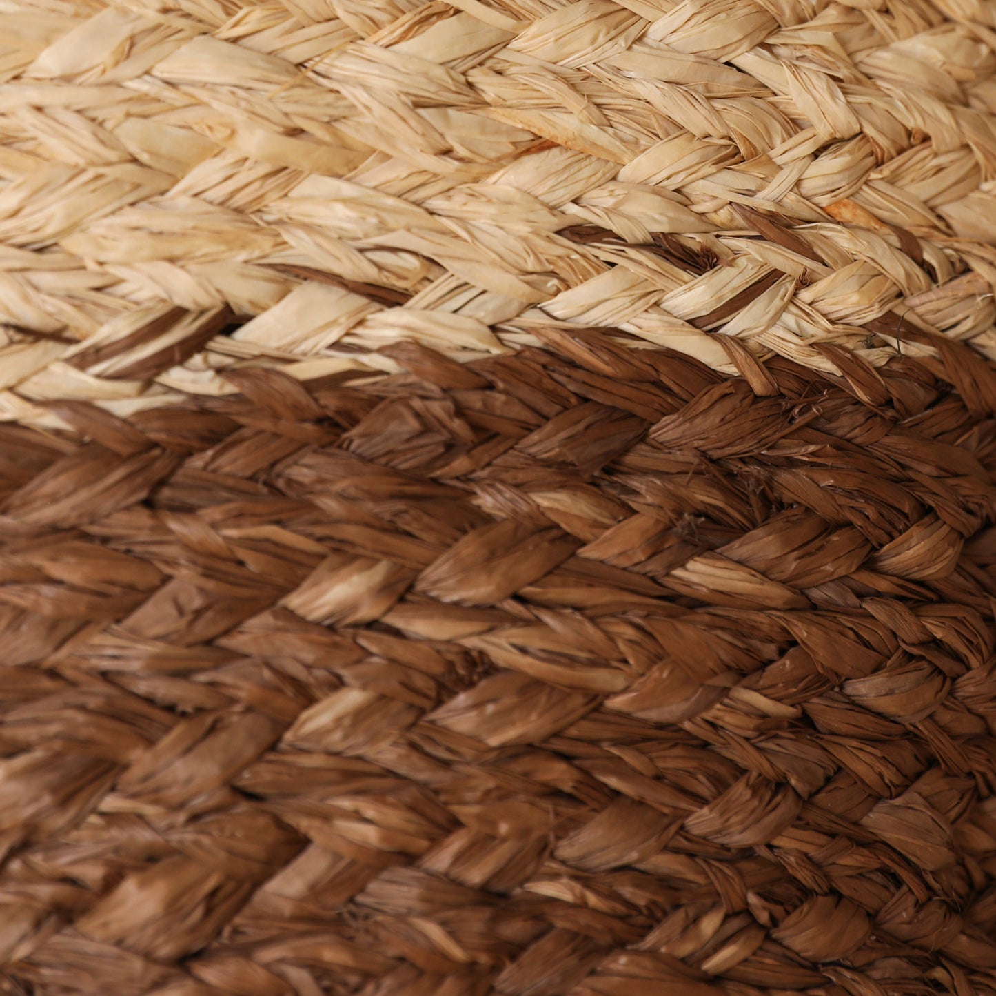 Close-up of a raffia plait section of a bag, brown and natural colour raffia